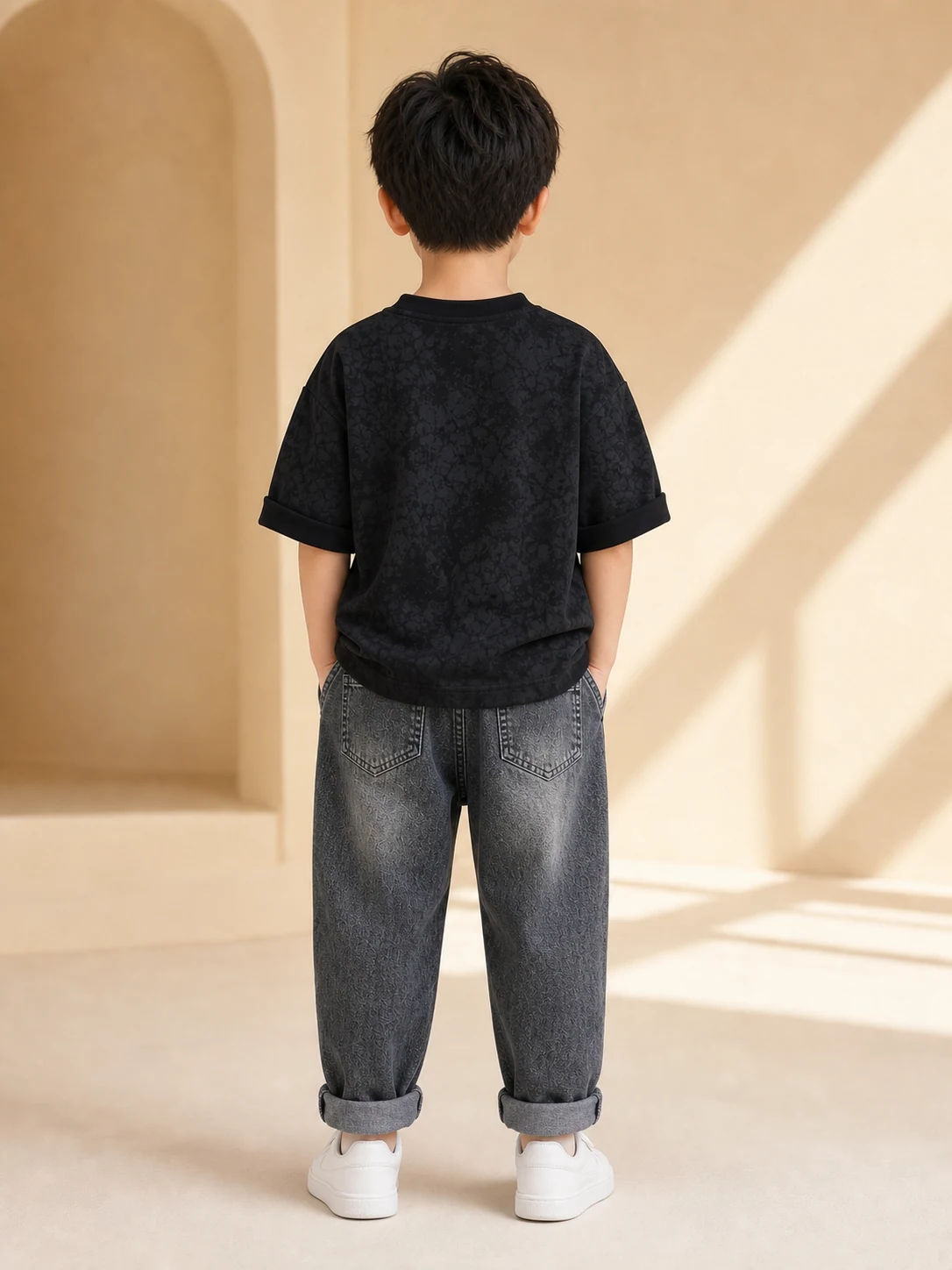 Boy wearing a black printed T-shirt and washed charcoal denim jeans set