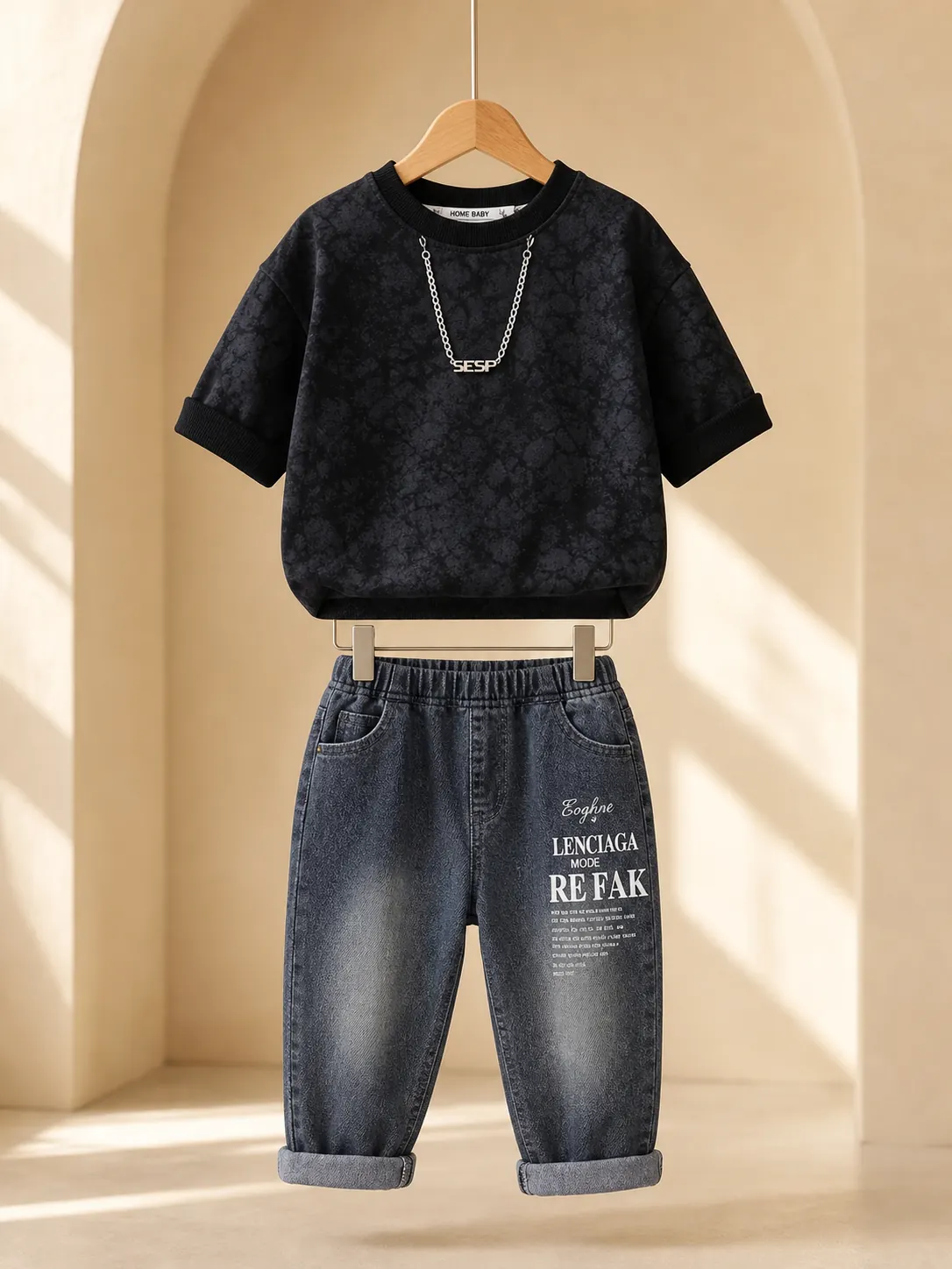 Boy wearing a black printed T-shirt and washed charcoal denim jeans set
