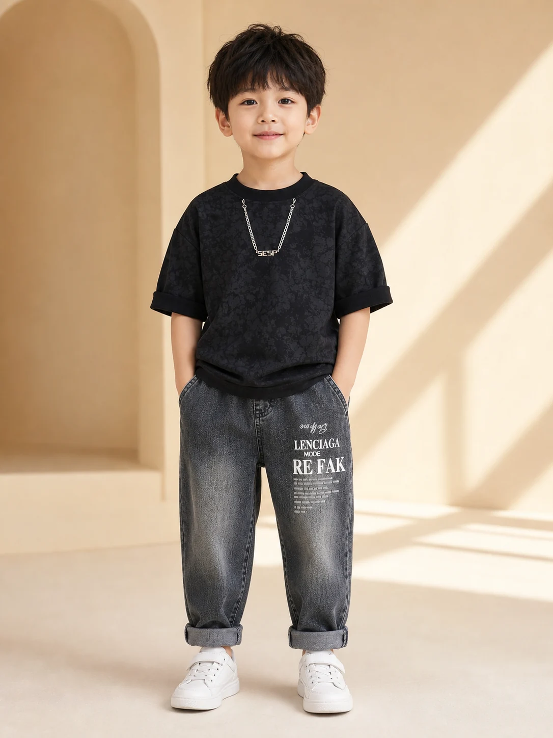 Boy wearing a black printed T-shirt and washed charcoal denim jeans set