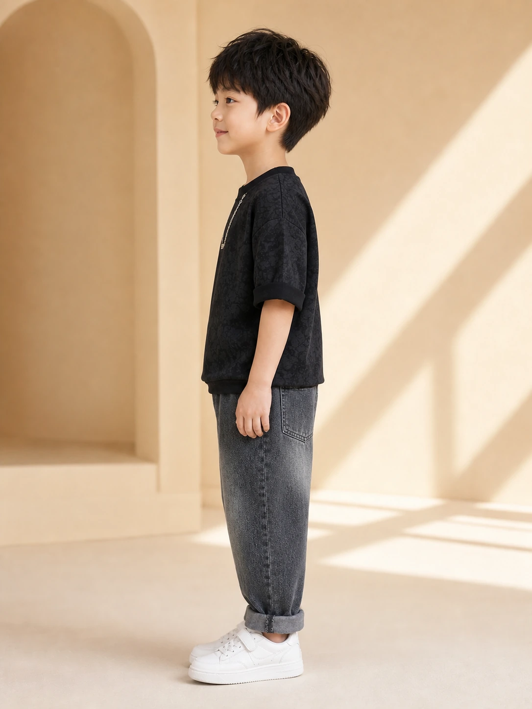 Boy wearing a black printed T-shirt and washed charcoal denim jeans set