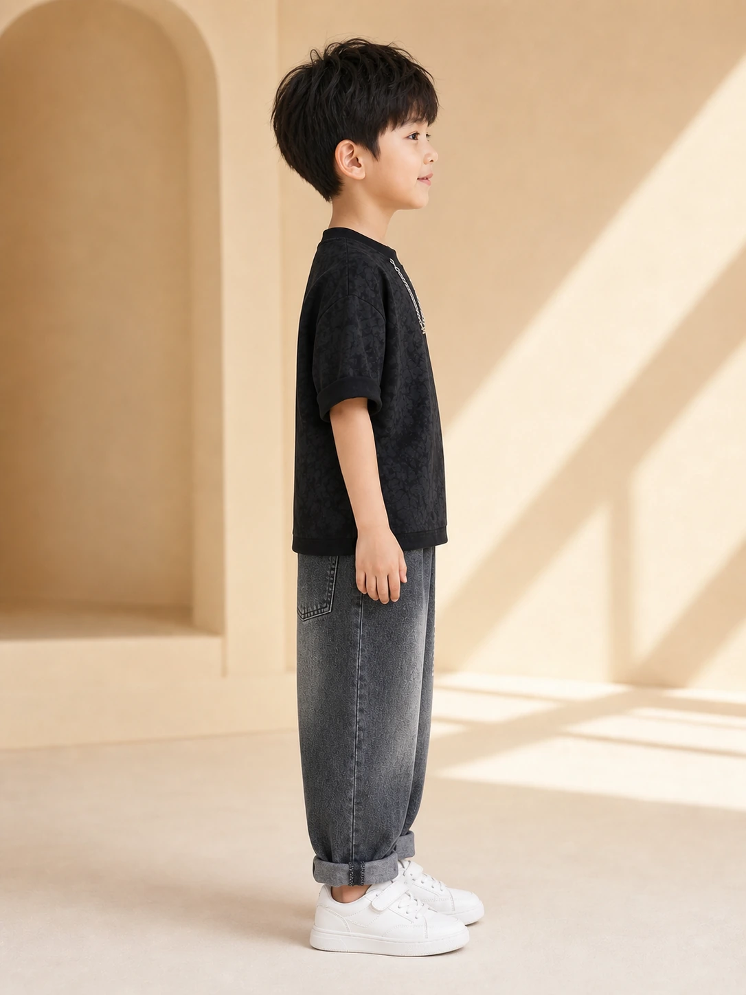 Boy wearing a black printed T-shirt and washed charcoal denim jeans set