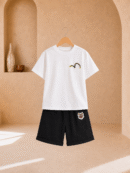 Boy wearing a white graphic T-shirt and black knee-length shorts