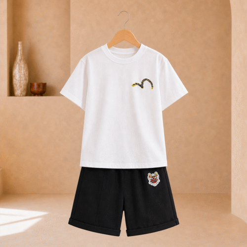 Boy wearing a white graphic T-shirt and black knee-length shorts