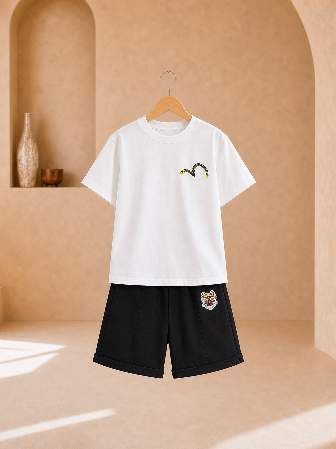 Boy wearing a white graphic T-shirt and black knee-length shorts