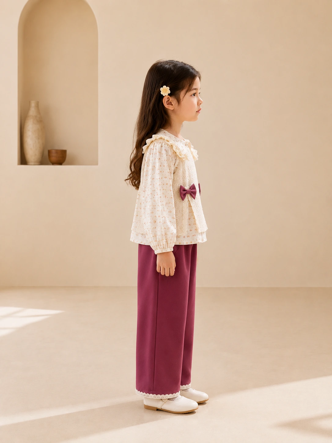 Girl wearing a three-piece floral top, lace jacket and magenta pants set