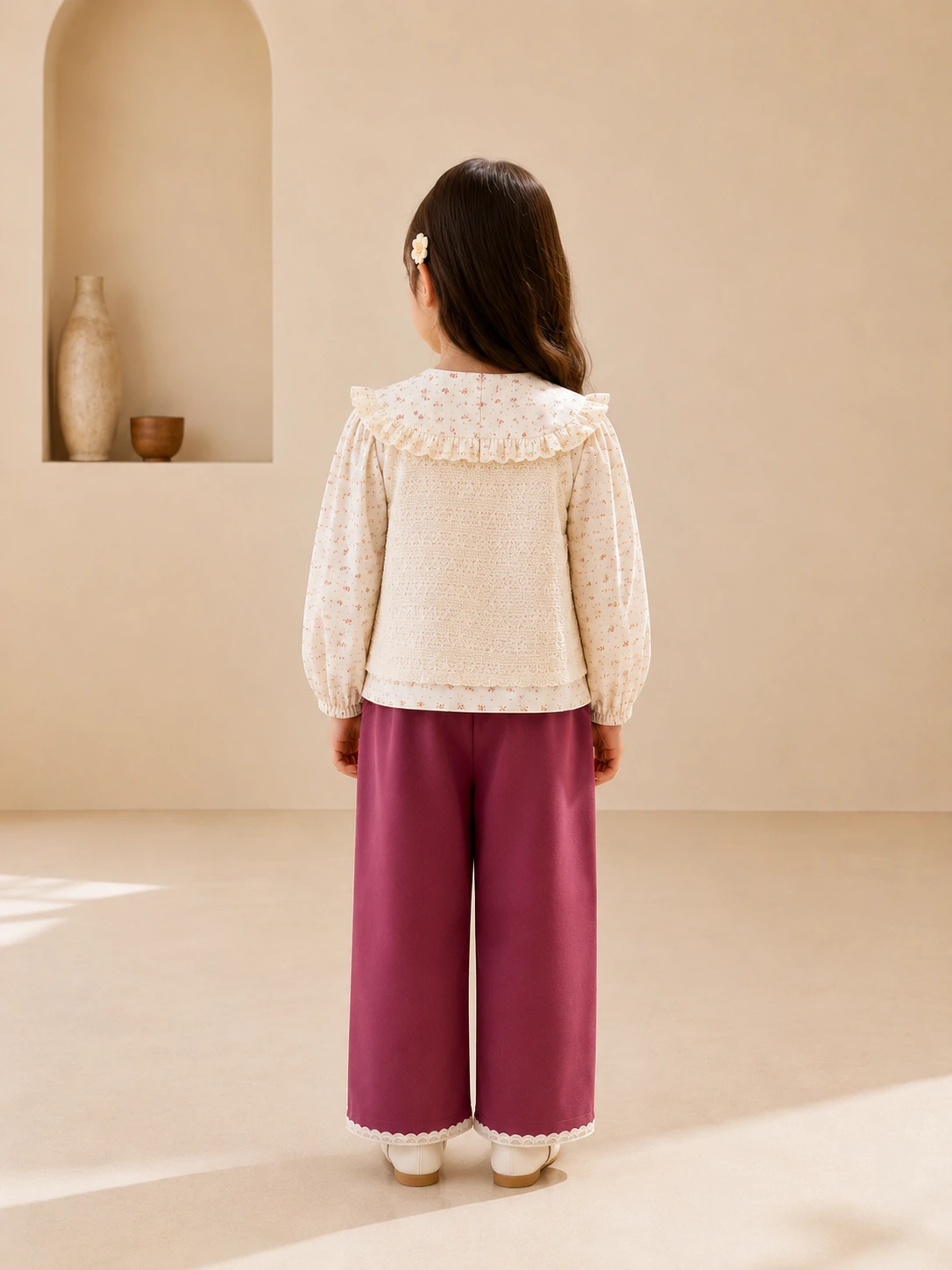 Girl wearing a three-piece floral top, lace jacket and magenta pants set